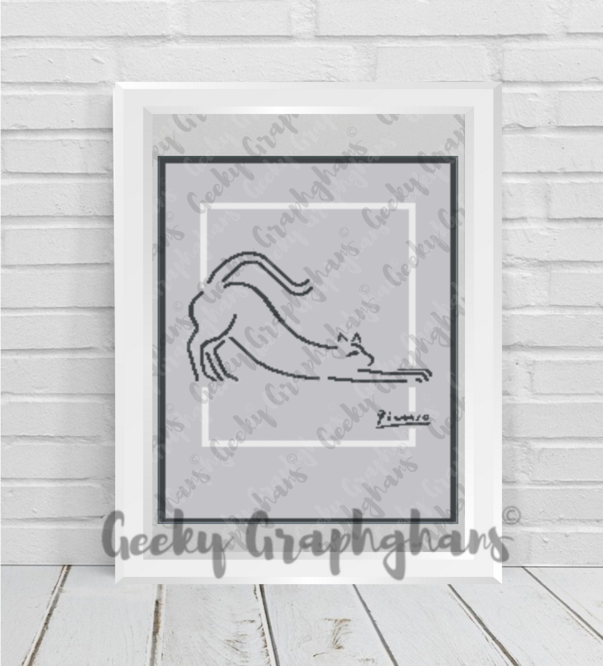 Cat sketch by Pablo Picasso. Crochet Graphghan. Framed black and white drawing of a cat on a textured wall with 'Geeky Graphghans' branding.