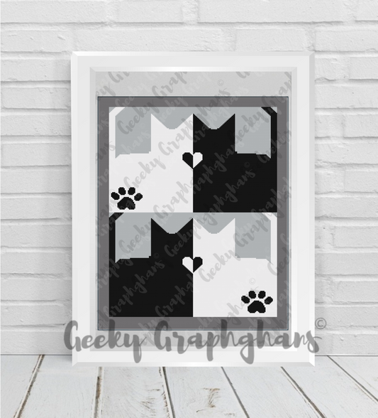 Framed black and white cat-themed crochet graphghan on a wooden floor. Crochet Graphghan pattern by Geeky Graphghans