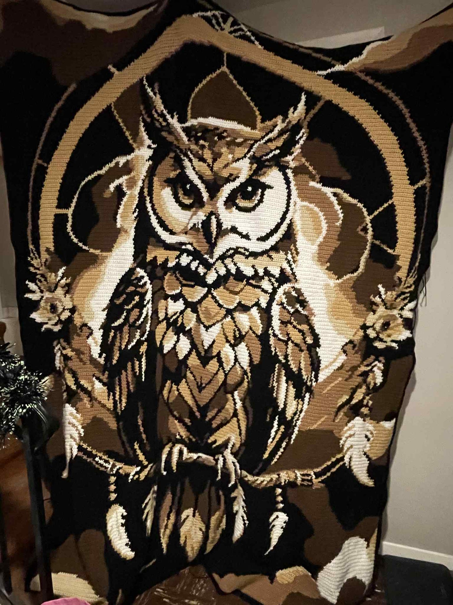 Decorative crochet graphghan blanket with an owl design on dreamcatcher motif. Design by Geeky Graphghans