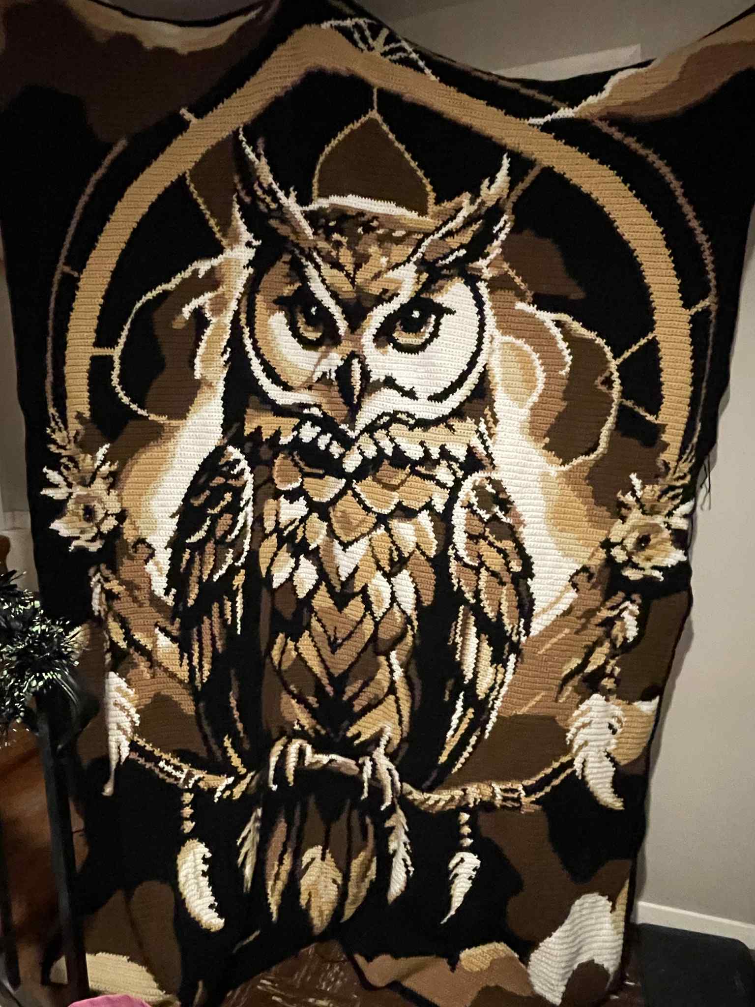 Decorative crochet graphghan blanket with an owl design on dreamcatcher motif. Design by Geeky Graphghans