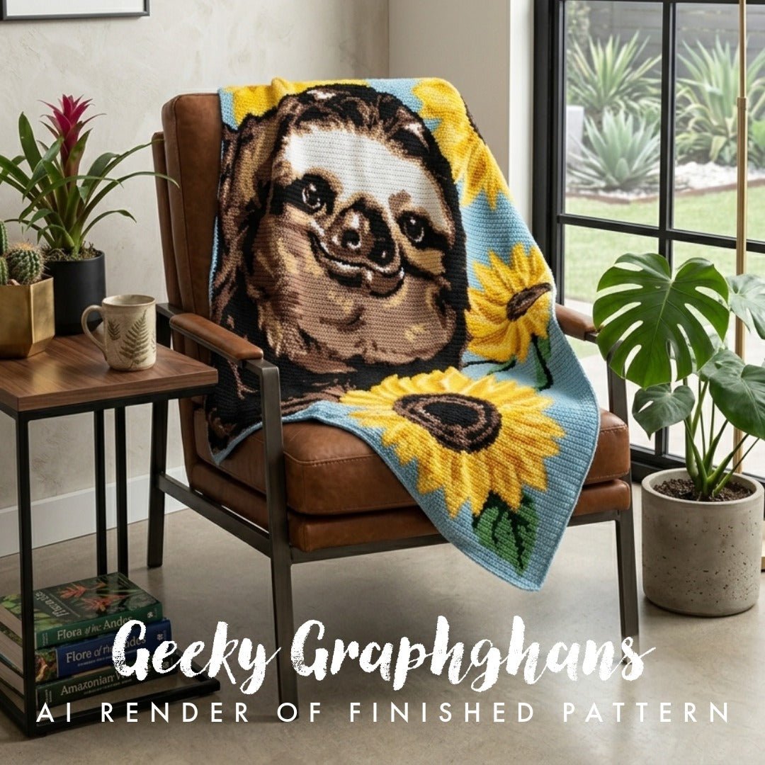 A crocheted throw blanket draped over a brown leather armchair in a styled room. The blanket features a large sloth face surrounded by bright yellow sunflowers on a light blue background. Sloth in Sunflowers crochet graphghan pattern by Geeky Graphghans