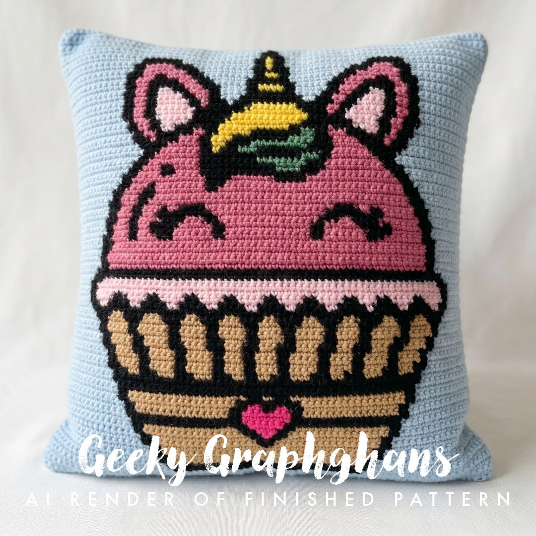 Crocheted pillow with a unicorn cupcake design on a light blue background, featuring the brand 'Geeky Graphghans'.