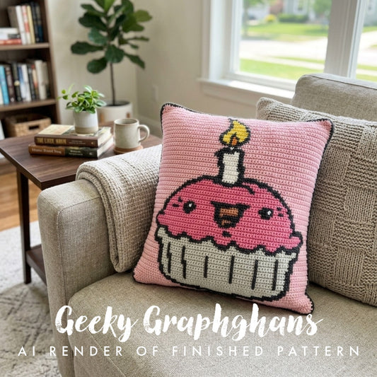Crocheted pillow with a cupcake design on a couch in a living room setting.