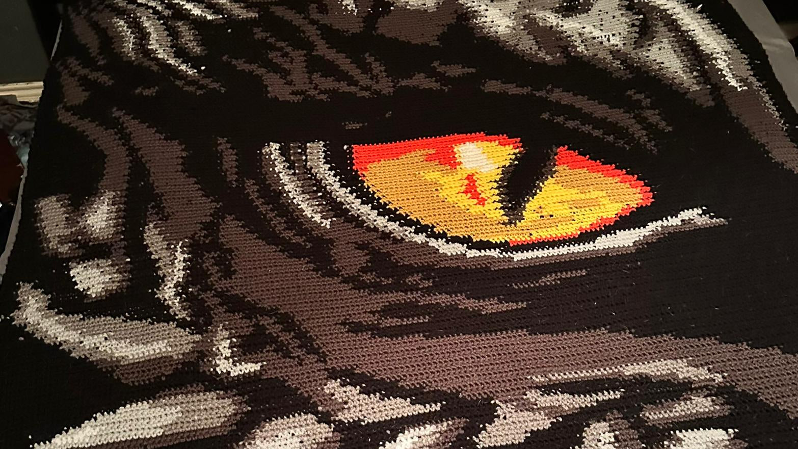 Close-up of a ctochet dragon ey design with detailed eyes.