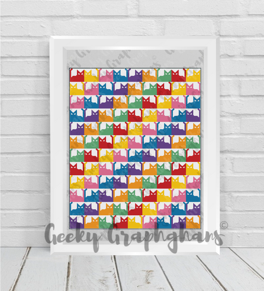 Framed artwork with colorful cat pattern on a wooden floor. Crochet Graphghan pattern by Geeky Graphghans