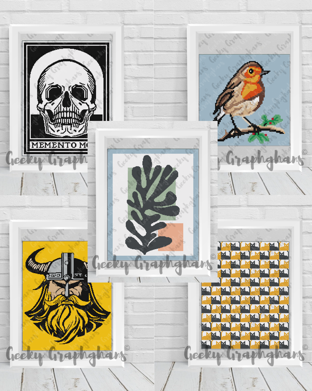 Collection of framed artworks on a white wooden surface. Crochet Graphghan patterns by Geeky Graphghans