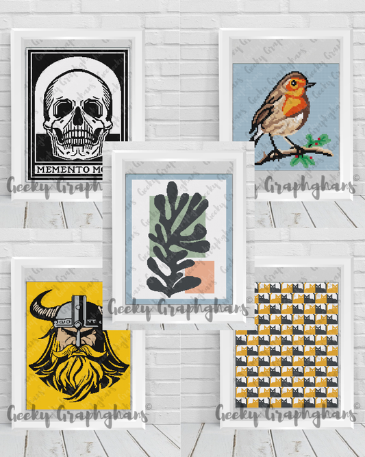 Collection of framed artworks on a white wooden surface. Crochet Graphghan patterns by Geeky Graphghans