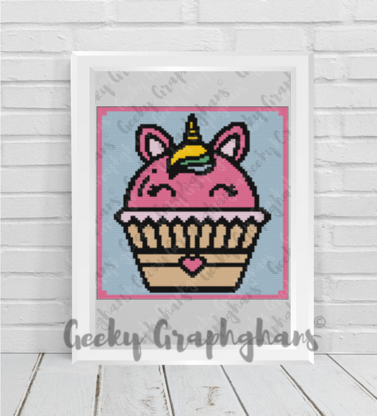 Pixel art of a cupcake with unicorn horns on a wooden surface, framed by 'Geeky Graphghans'.