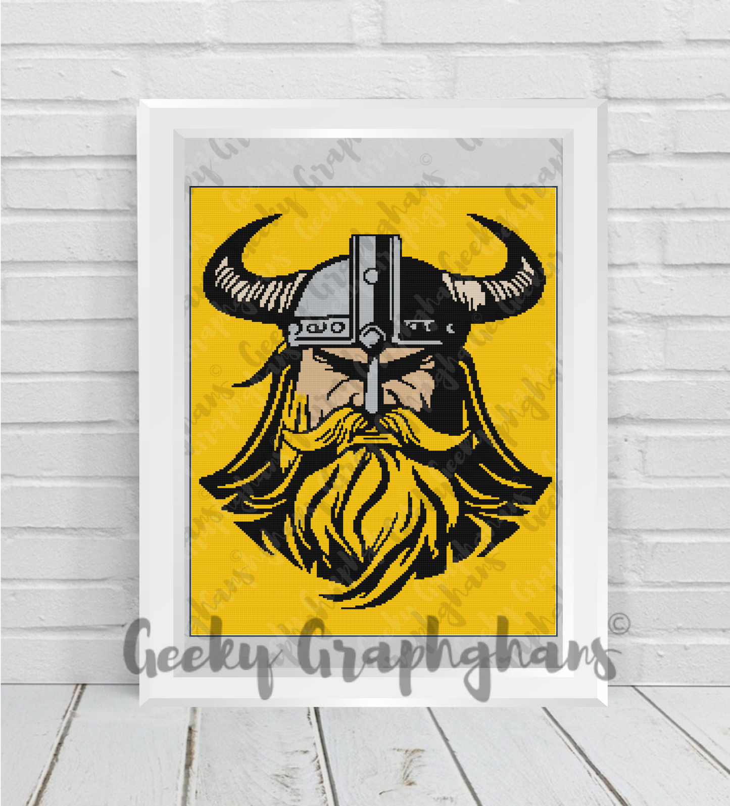Viking Crochet Graphghan with a beard and helmet on a yellow background, framed by Geeky Graphghans. Crochet Graphghan pattern by Geeky Graphghans