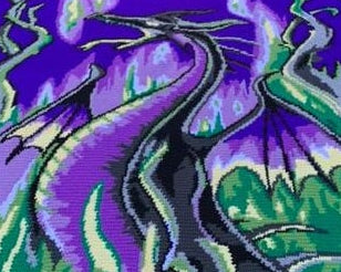 Crocheted blanket with a dragon design on a grassy background